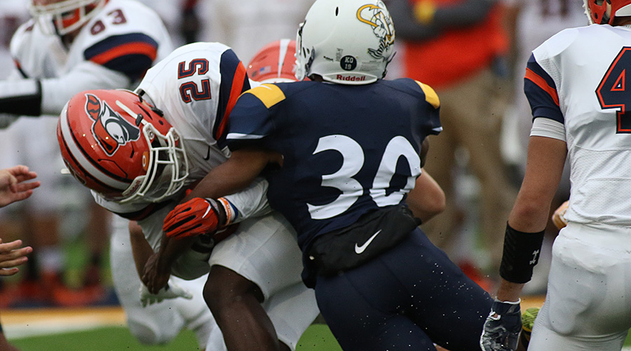 Dionte Moses tackling a Carroll ballcarrier