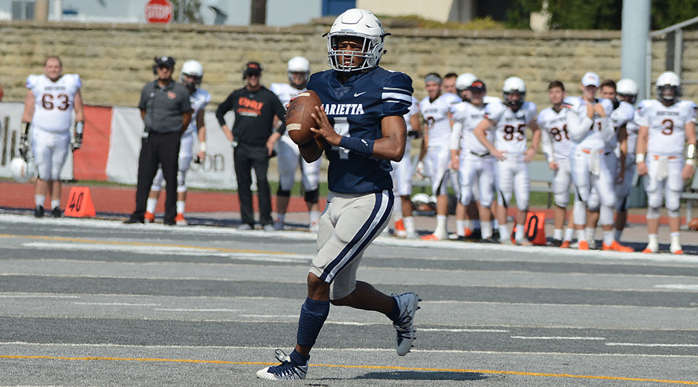 Darrien Fields rolls out on Marietta's gray turf. (Marietta athletics photo by Katie Gallagher)