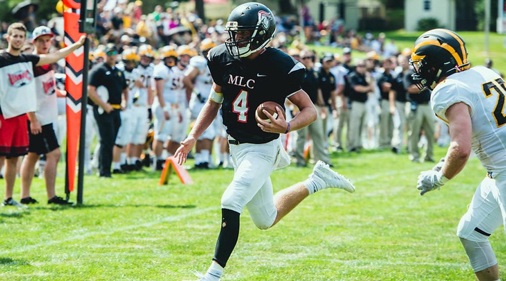 Zach Bloomquist runs away from a Gustavus Adolphus would-be tackler in a Sept. 1, 2018, file photo. (Martin Luther athletics file photo)