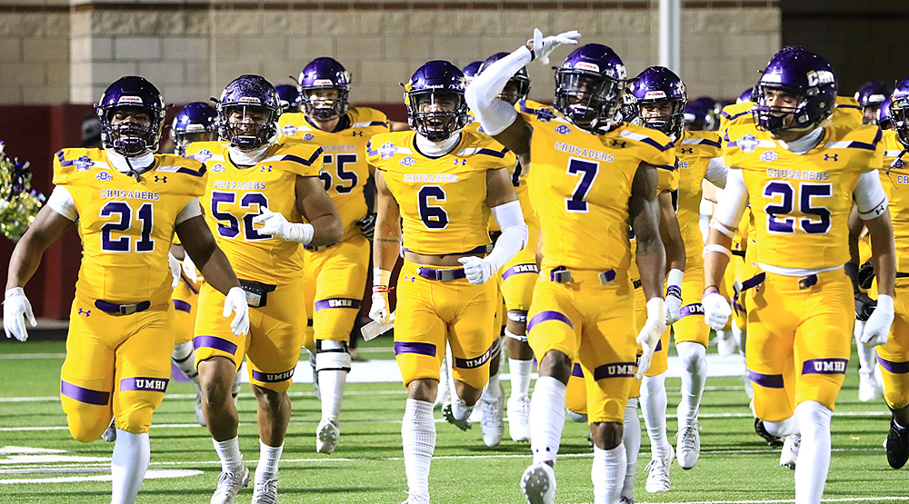 Mary Hardin-Baylor, including seniors Markeith Miller, Santos Villarreal, Reggie Cole and Raylon Hickey, take the field before Stagg Bowl XLVI. (Photo by Joe Fusco, d3photography.com)
