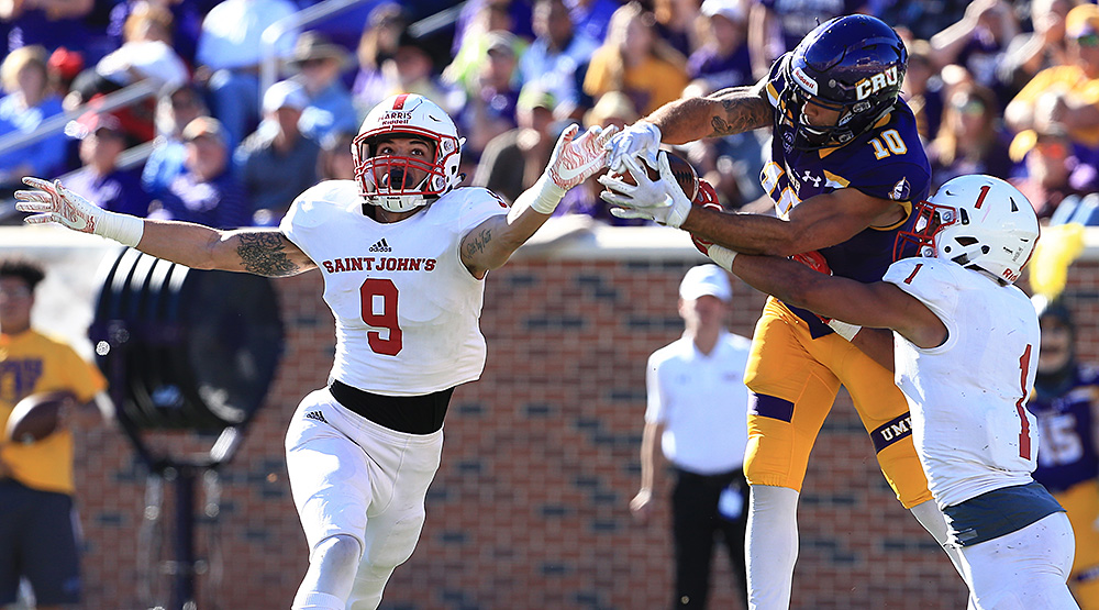 T.J. Josey comes up with the catch between St. John's defensive backs Chris Harris and Max Jackson. (Photo by Joe Fusco, d3photography.com)