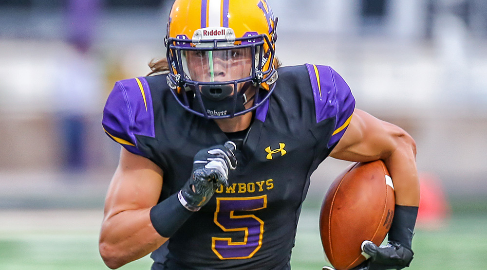 Reese Childress runs with the ball along the hash marks. Photo by Monica Weatherly, Hardin-Simmons athletics